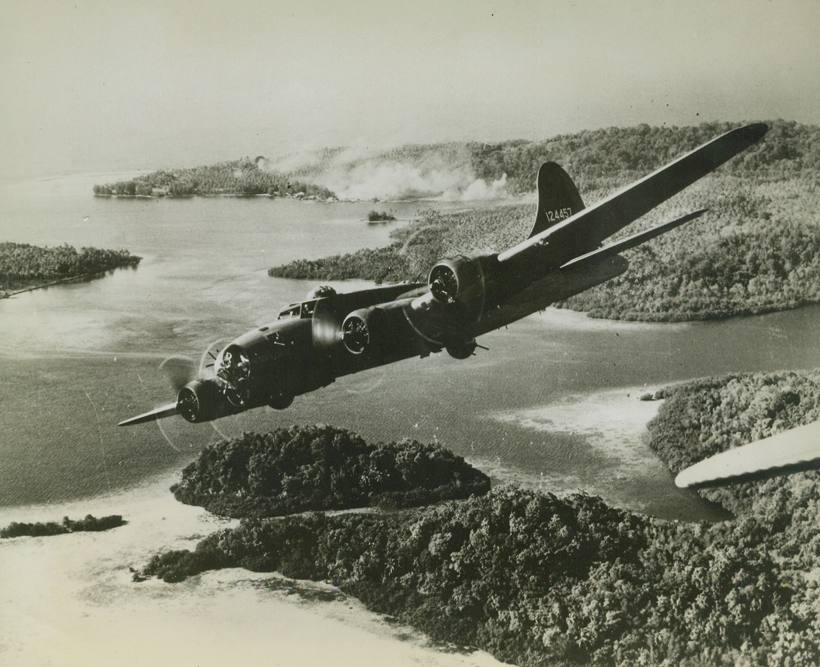 Fortress Foray in Solomons, 2/23/1943. Solomon Islands – After unleashing fire and destruction on Jap installations on Gizo island (right rear), a U.S. Flying fortress wings back toward its home base with other four-motored champions of the sky.  The raid was part of a triple-pronged aerial thrust against the enemy during the fight for Guadalcanal. Credit (Official U.S. Navy photo –ACME);