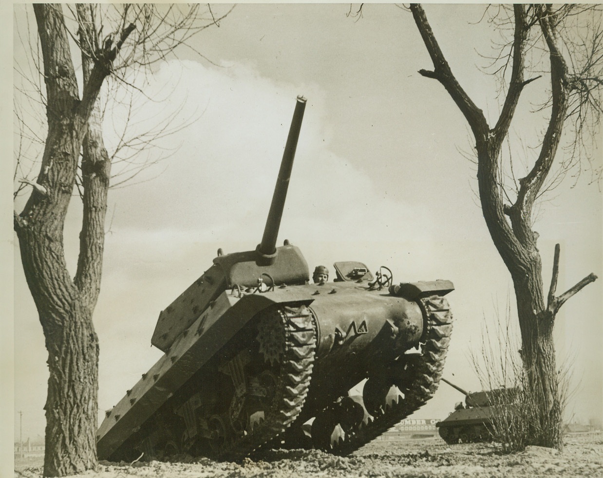 New Tank Busters Go Through Their Paces, 3/14/1943. DETROIT, MICH. – Two new M-10 tank destroyers go through a stiff workout on the Ford Motor Co. test grounds. Stripped of many of the engineering refinements found on the medium tank in order to gain speed (they both come off the same production line). The M-10 packs a greater wallop with its 3-inch gun. Credit: (ACME);