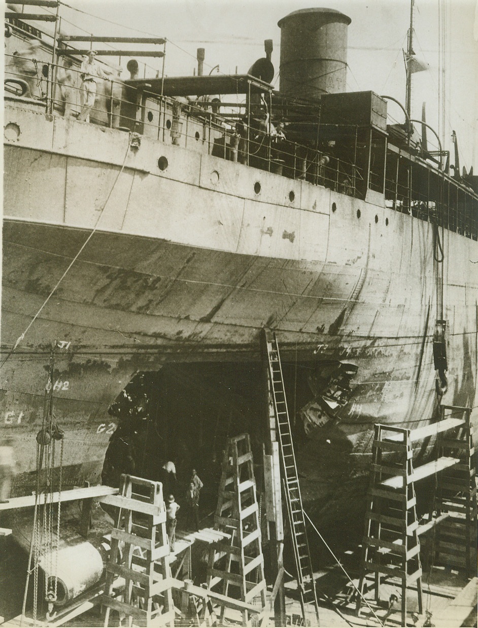 Goes to War Again, 6/16/1943. NEW YORK – Here’s a United Nations ship that was struck by a torpedo. It is shown here just after arrival at a yard of the Todd Shipyards Corp. Officials point out that when a torpedoed ship is drydocked, the gaping jagged hole is clearly visible. Experts must survey and repair the internal damage, which is usually much more serious. The vessel was repaired in record time and is again doing “sea duty.” Credit: (ACME);