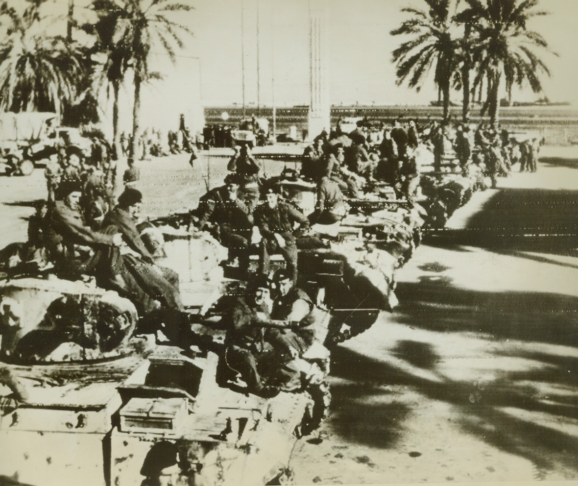 First Photos of Tripoli’s Fall, 1/25/1943. Tripoli—Rows of British Eighth Army tanks are drawn up in the main square of Tripoli, after Allied forces had captured this former Axis stronghold. In the background (photo above), can be seen the harbor. This photo, received by radio in New York today, is one of the first to be transmitted after Tripoli’s fall. Passed by censors.Credit: ACME radiophoto.;