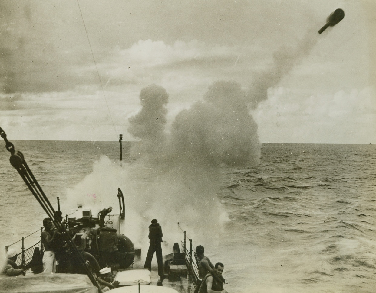 An “Ashcan” in Flight. 1/26/1943. A depth charge is fired from a “Y” gun by a RC boat patrolling the coast. Speedy, maneuverable submarine chasers like these are helping to cut the submarine shipping toll along the Atlantic coast. Credit: Official U.S. Navy Photo from ACME;