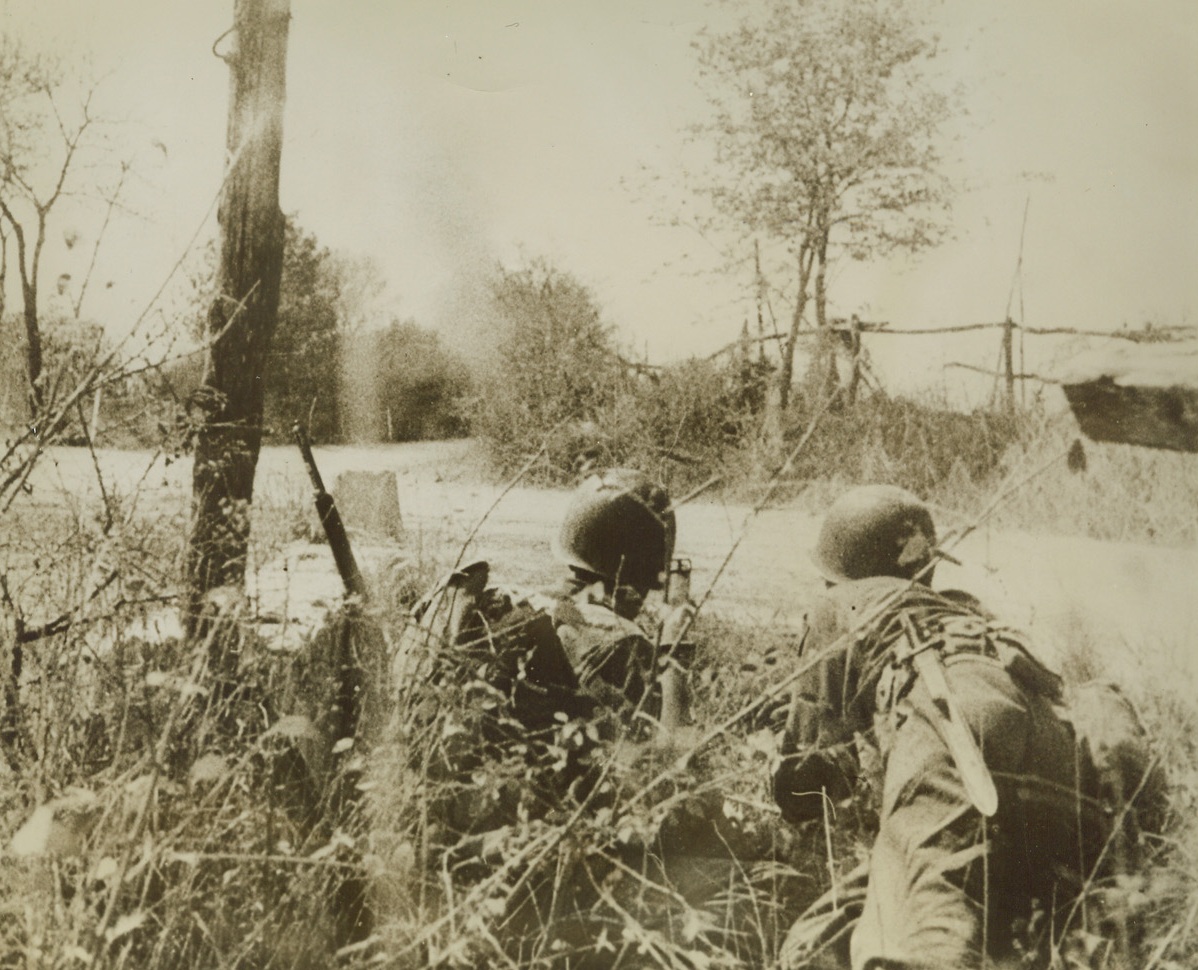 WAITING TO ADVANCE, 9/30/1943. SALERNO, ITALY—Tow Americans of the U.S. 5th Army, hug the ground waiting for the word to advance, in the bloody Battle of Salerno. Man on the left seems to be holding a “bazooka” ready for any Nazi tank that appears. Today, 5th Army forces are closing in on Naples and the fall of that city is expected momentarily. Credit: Newsreel pool photo from Acme;
