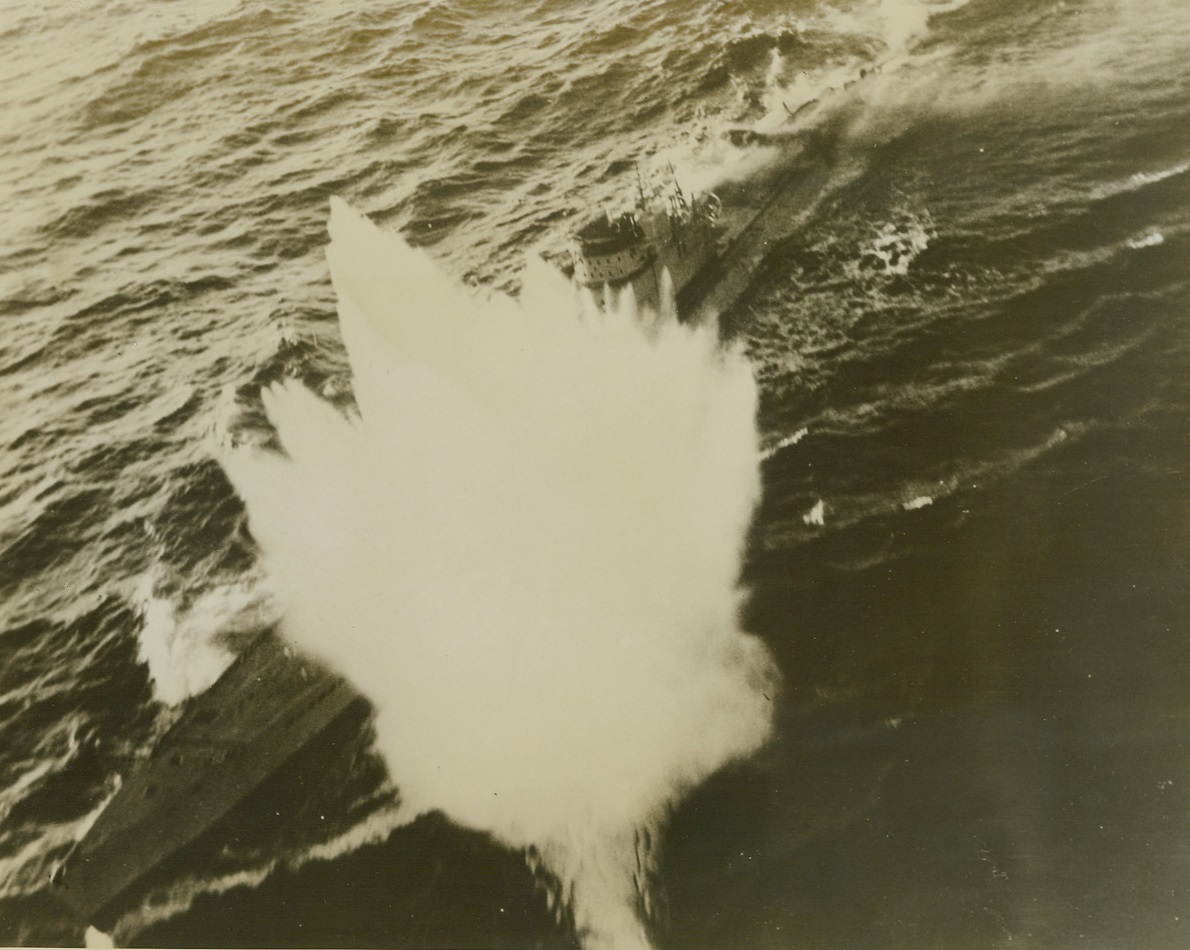 U.S. Navy Plane Downs 3 Nazi Subs, 9/28/1943. WASHINGTON, D.C. - One, lone U.S. Navy Grumman Avenger (TBF) Torpedo Bomber flying from an escort carrier in the Atlantic, has made history by definitely sinking 3 Nazi U-Boats in 4 days and damaging another, according to announcement in Washington today. Lt. Robert P. Williams, USNR, and his two-man crew not only escaped unscathed in the attacks, but produced excellent pictoral evidence of the "kills". Here, during their fourth "sub-blitzing" attack, Lt. Williams' plane drops a depth charge near a fully surfaced sub. Smoke pours from the afte end, (top, right in photo), of the sub, which sank a short time later - it was the third definite "kill" for the gallant Navy crew of the torpedo bomber.;