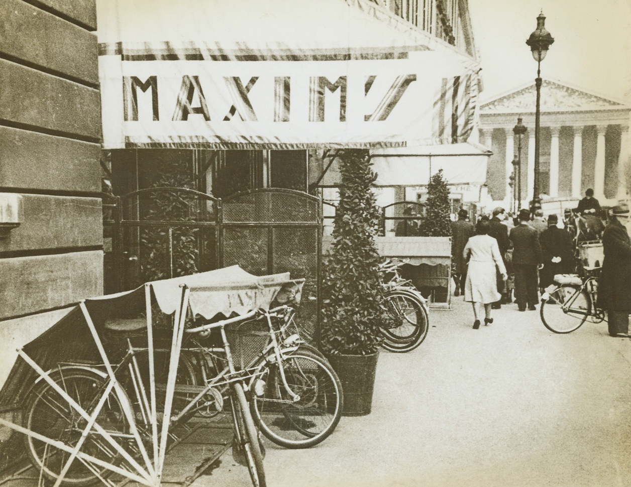 ”I’m Going to Maxim’s” – On a Bicycle, 9/2/1943. Paris – Parisians have almost forgotten what it was like to drive around in motor cars. They get along as best they can with bicycles and horse-drawn vehicles. Typical is this bicycle garage in front of Maxim’s, the night club made famous in story and song. Credit: ACME;