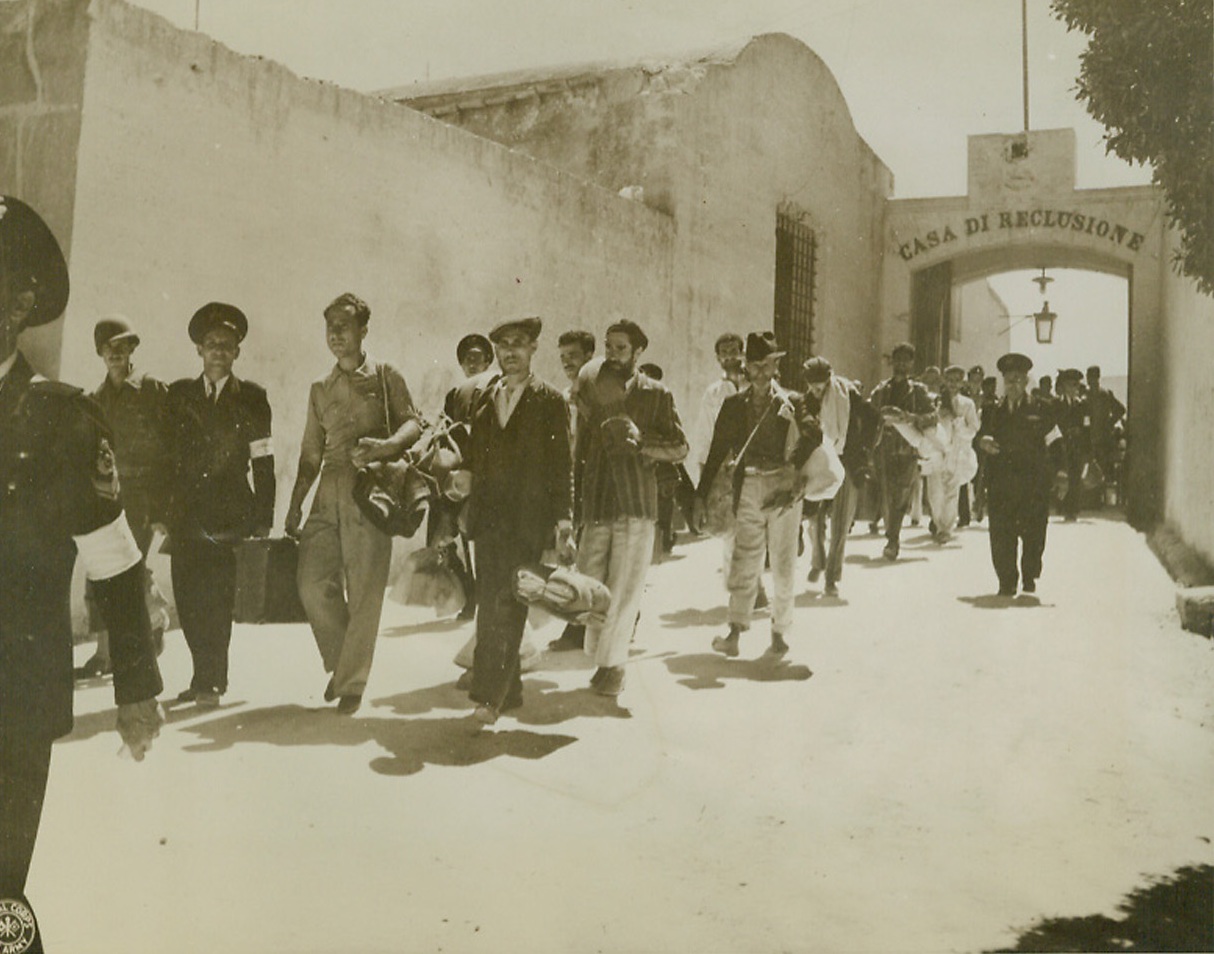 Anti-Fascist Go Free, 10/13/1943. FAVIGNANA – Political prisoners of the Fascist regime, who were interned on the island of Favignana, off the west coast of Sicily near Trapni, were release when the Allied Military Government assumed control of the island. The anti-Fascists carry their belongings as they march to the boat that took them to the Sicilian mainland.Credit: (Official U.S. Army Photo from ACME);