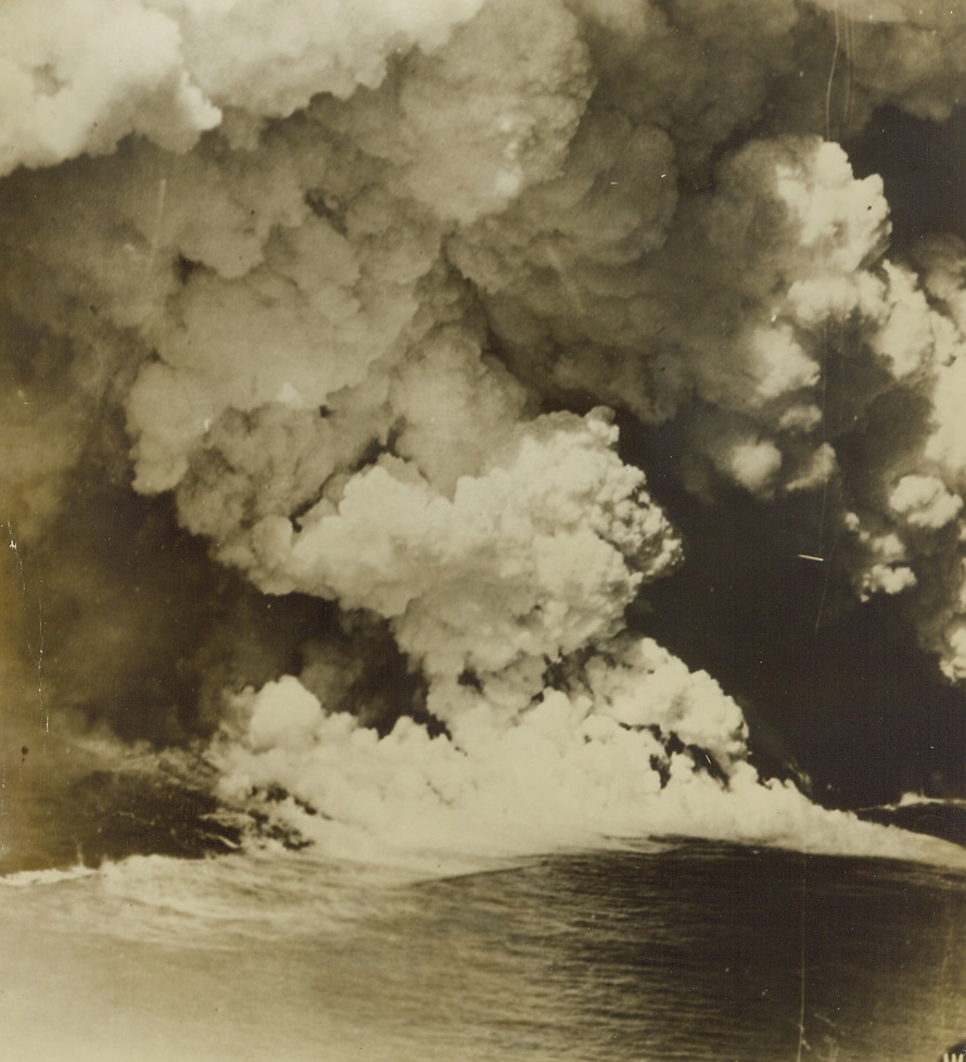 Nature Follows Suit, 10/14/1943. Not to be outdone by air raids and naval battles in the war-torn Pacific, Dame Nature staged a spectacular show of her own last Sept. 26 on Niuafoo Island, in the Samoan group, where this photo of a volcanic eruption was taken from a U.S. Marine transport plane. The last volcanic disturbance on the island, which is inhabited by 1,100 Polynesians, was in 1929 and the next one was not scheduled until 1945. Here, (photo above), smoke pillars 25,000 feet into the sky from a fissure a mile and a half long, while streams of lava pour into the sea. Credit: U.S. Marine Corps photo from ACME;