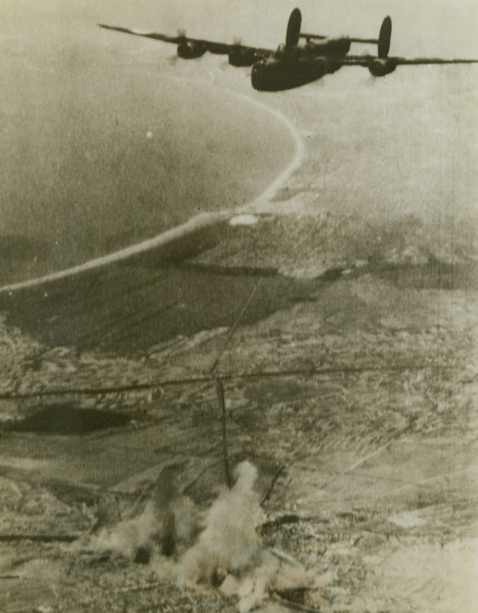 Bombing Pisa, 10/2/1943. Operating under the direction of the Northwest African Air Forces, B-24 Liberators bombed targets at the Pisa marshalling yards in Northern Italy.  Buildings were severly damaged and the main line to Florence and the East was out.  Here one of the planes is shown over the target.Credit line (Signal Corps radio telephoto – ACME);