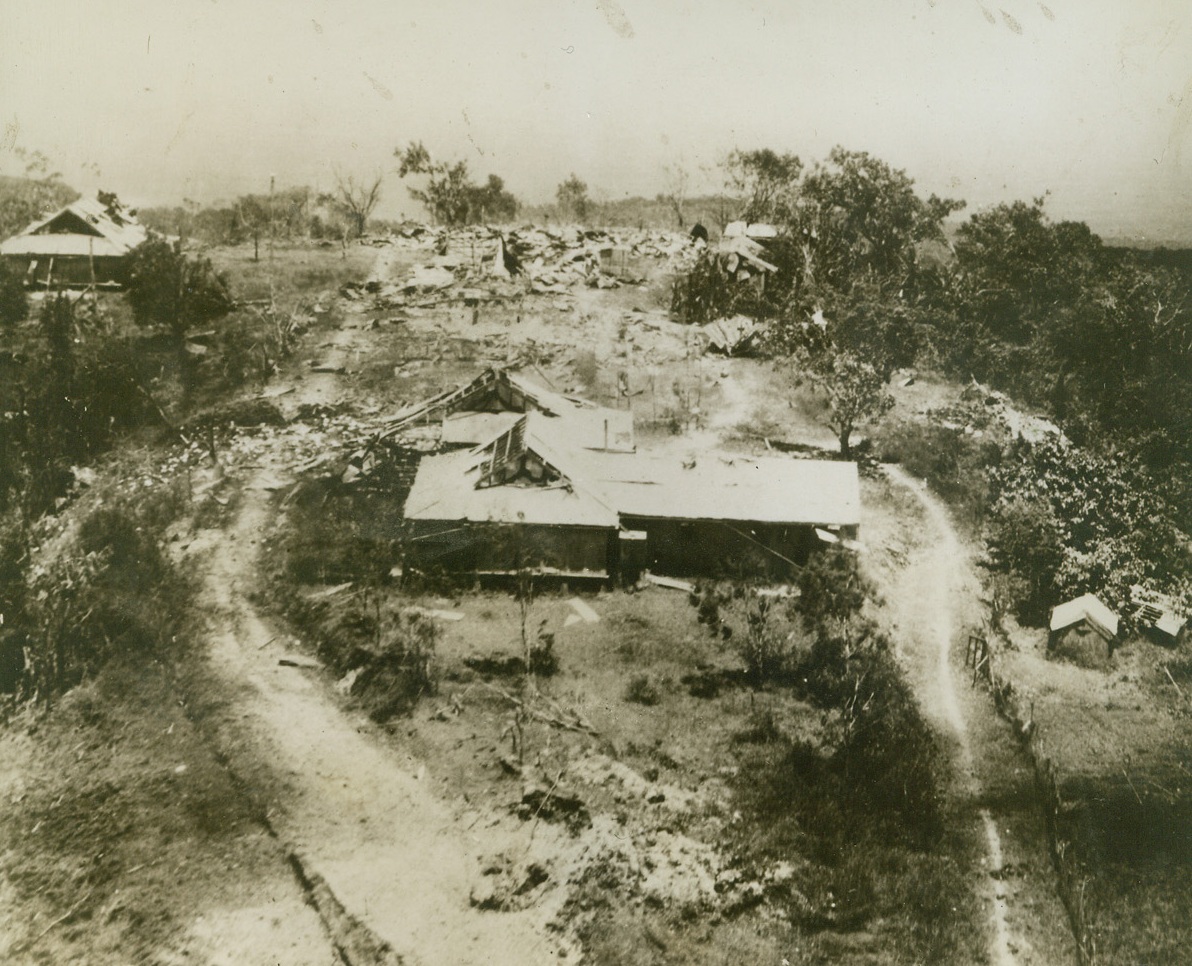 Once A German Mission Station, 11/27/1943. SATTLEBERG, NEW GUINEA – Ruined by U.S.A.A.F. bombers, this former German mission station at Sattleberg was used by Japs as a fortified point before the Aussies captured the town on November 27th (New Guinea time). While the installation’s flimsily constructed buildings were few in number, they could easily have concealed heavy guns to retard the advance of Allied ground units. Credit (U.S. Army Air Forces Photo from ACME);