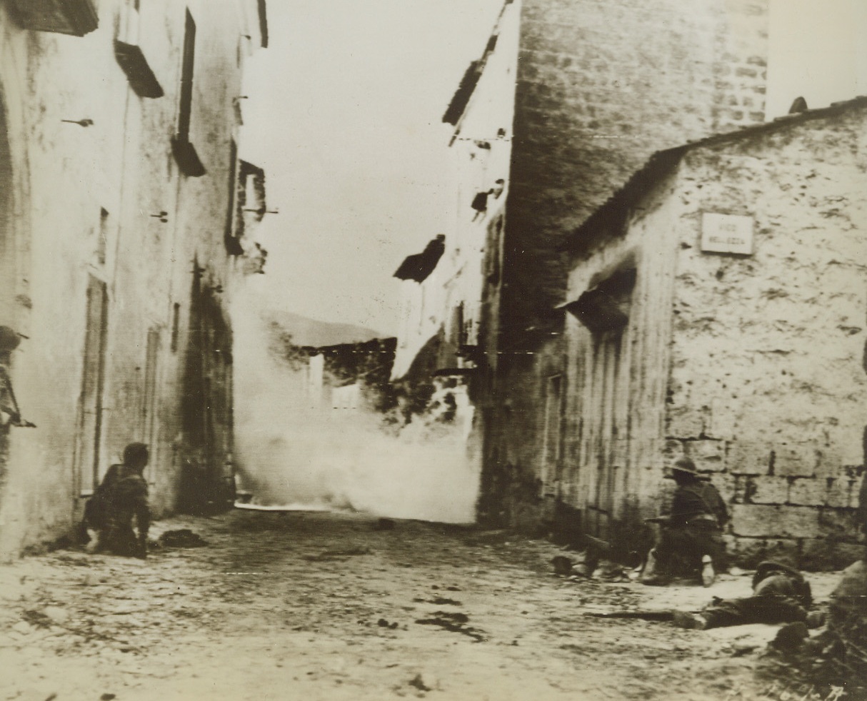 Good Day to Stay Indoors, 11/6/1943. ITALY—Bullets fly thick and fast as members of a British patrol seek out the enemy in some furious street fighting in Nocelleto, Italy. Credit: ACME photo via SIGNAL CORPS RADIOTELEPHOTO.;