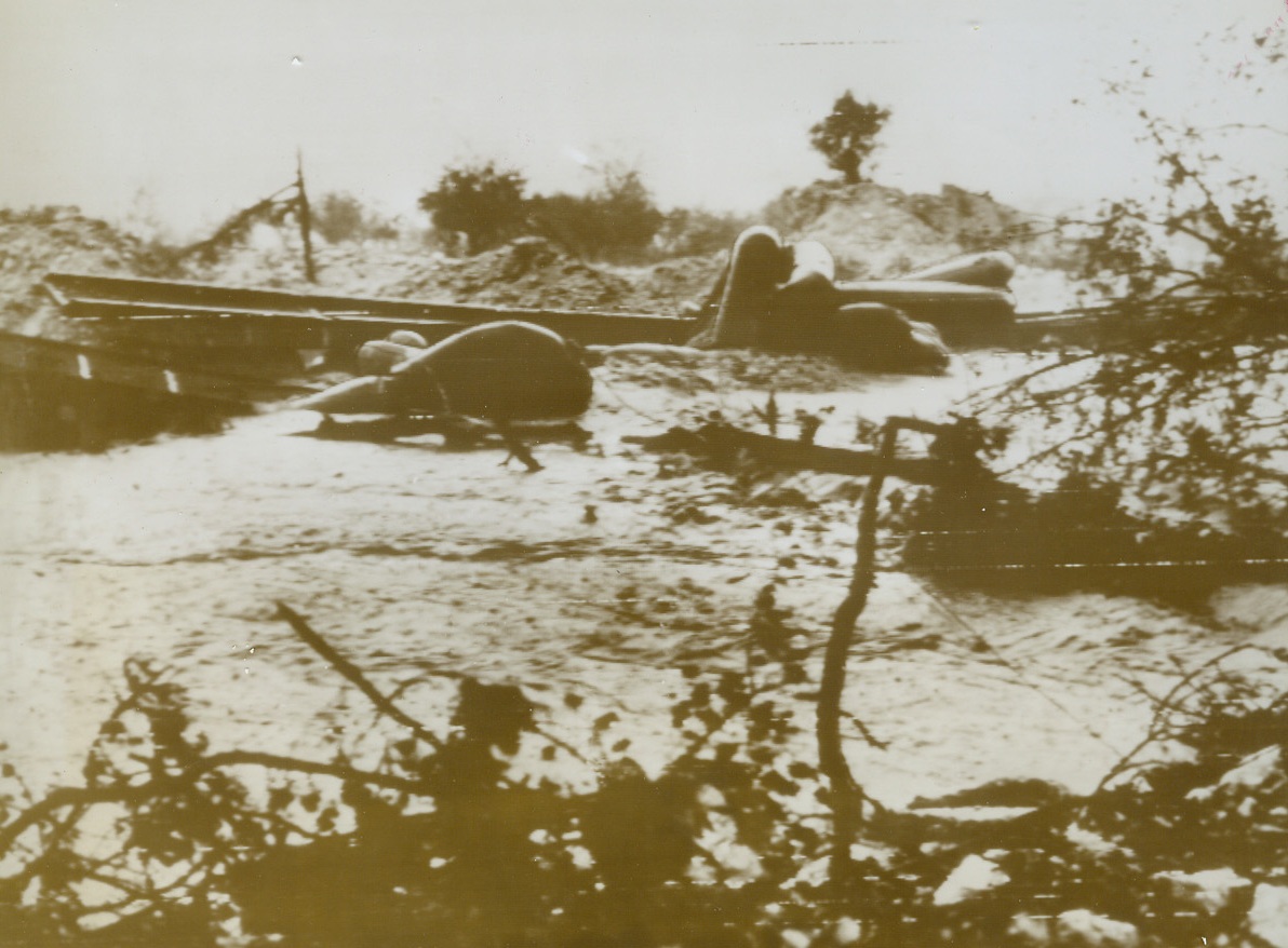 FLOODWATERS WRECK PONTOON BRIDGE, 11/21/1943. ITALY—Heavy winds and rain played havoc with this pontoon bridge over the Volturno River just north of Venafri, Italy. The pontoons washed out by flood waters, can be seen floating at random in the river. In spite of quagmires, Gen. Clark’s Fifth Army has advanced five miles on the road to Rome in the direction of Alfedena, an Allied Headquarters dispatch said today. Credit (Signal Corps Radiotelephoto from ACME);