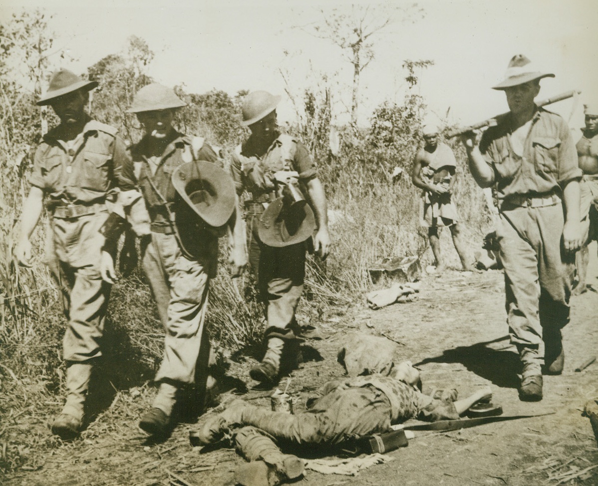 Dead Jap at Lae, 11/9/1943. Lae, New Guinea – Australian soldiers moving up to the front near Lae, step around this dead Jap – one of Lae’s defenders killed in the fighting that resulted in the Allies’ capture.Credit Line (ACME);