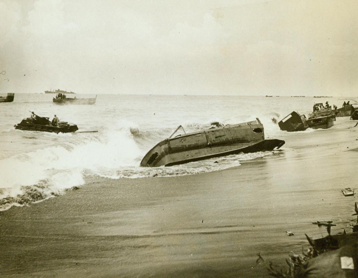 "High And Dry" At Bougainville, 11/23/1943. When the tide went out at Bougainville in The Solomon Islands, these landing craft which brought U.S. Marines ashore for the invasion of the Jap-held island, were left beached. 11/23/43 (ACME);
