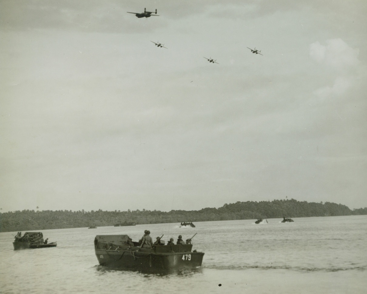 Bombers Protect U.S. Troops Landing on Arawe, 12/28/1943. Covered by B-25s of the U.S. Fifth Air Force, a group of landing craft head for beach at Arawe, New Britain, on southwestern coast. Landing was made and beachheads established in drive to clear the island of Japanese. Credit: ACME photo by Tom Shafer for War Pool;