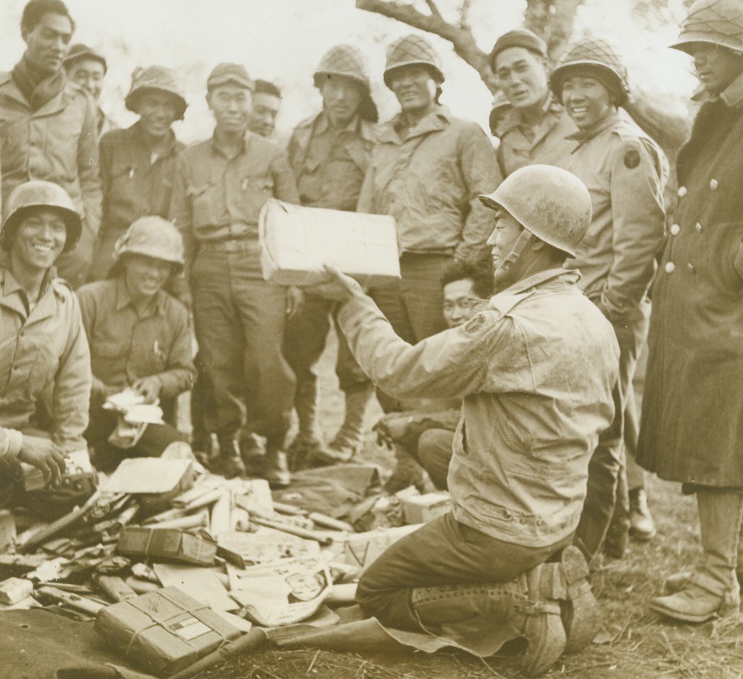 Only Hate For Hirohito, 12/4/1943. JAPAN—A package of rice sent all the way from Honolulu draws amazed cheers from the U.S. Army Japs in their bivouac as mail arrives. Credit: ACME;