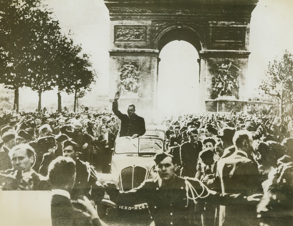 Heil! Heil! The Gang’s All Here!, 12/4/1943. Paris –The Germans probably meant this photo, received through neutral sources, as a neat little piece of propaganda, showing the leader of the French Popular Party taking a triumphal ride through the streets of Paris. However, the camera tells the truth as the French citizens greet the “leader” with the upraised hand salute of racism. Credit: ACME;