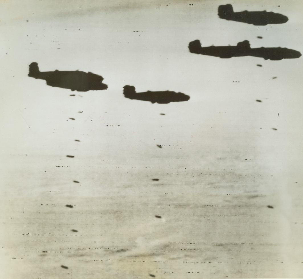 Laying “Eggs” Over Axis Positions, 10/28/1942. Western Desert—A formation of U.S.-built Mitchell (B-52) bombers drop their loads of bombs over the enemy in the Western Desert as the RAF continues its fierce “shuttle service” air attacks. Photo radioed from Cairo to New York today. Credit: ACME radiophoto.;