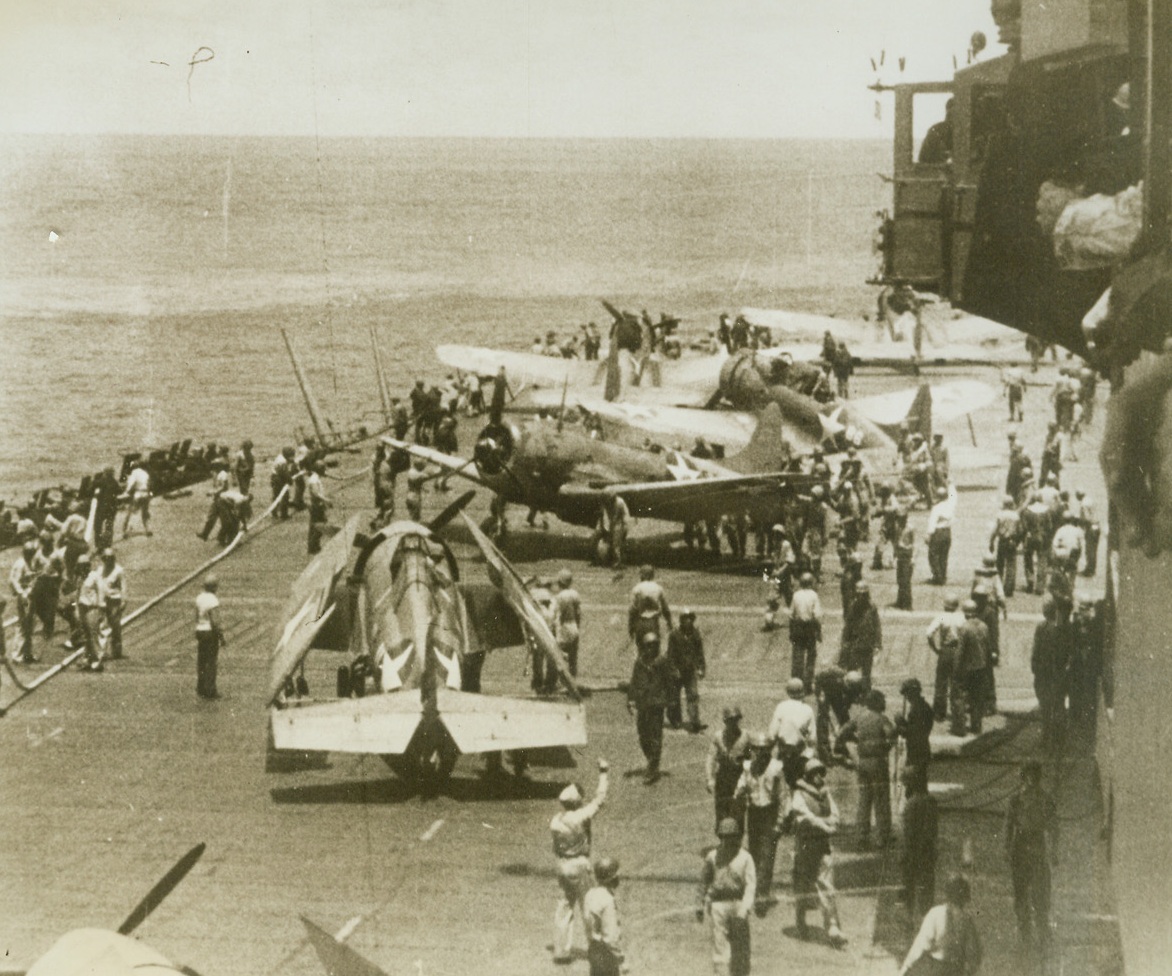 BATTLE’S END, 12/22/1942. After heavy action against a fleet of Jap bombers in a recent action in the South Pacific, American planes return to this U.S. aircraft carrier, are refueled and stowed away. This photo, taken from an official newsreel, has just been released in New York. In the battle, no American vessel was more than slightly damaged.  Credit: U.S. NAVY PHOTO FROM ACME.;
