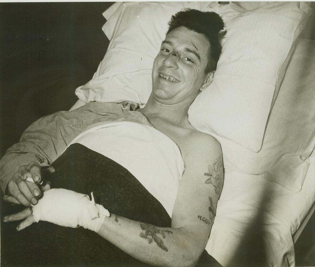 SURVIVOR OF ANDREWS CRASH, 5/25/1942. Sgt. George A. Eisel, who was the only survivor of the Iceland plane crash where Lt. Gen. Frank M. Andrews and 13 others met death, grins from his hospital bed in Iceland. The Columbus, Ohio soldier has survived another crash in North Africa that took the lives of three comrades. He holds the DFC, the Air Medal with three oak leaf clusters and the Purple Heart. Credit: U.S. Army Signal Corps photo via OWI Radiophoto from Acme;