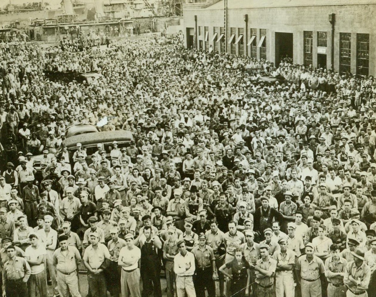 Charleston Navy Yard Workers' Labor Day Meeting, 9/8/1942. Charleston, S.C. -- Here's part of the large crowd of workers which attended the Labor Day celebration at the Charleston Navy Yard -- After day's work was over. Celebration included the laying of two keels for landing ships. Workers at the yard pledged to build more ships, better ships, and buy more bonds to finance ships. 9/8/42 (ACME);