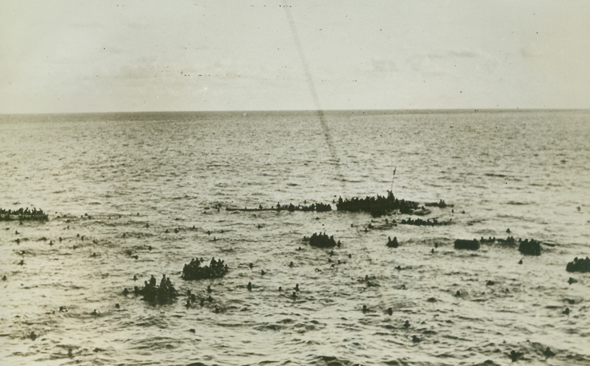 Rescue of Survivors from H.M.S. Dorsetshire Indian Ocean, 9/8/1942. Indian Ocean --  Hundreds of survivors of H.M.S., Dorsetshire cling to floating bits of wreckage, awaiting lifeboats from a rescuing British destroyer.  The Dorsetshire was one of two cruisers sunk during action in the Indian Ocean. Credit Line (ACME);