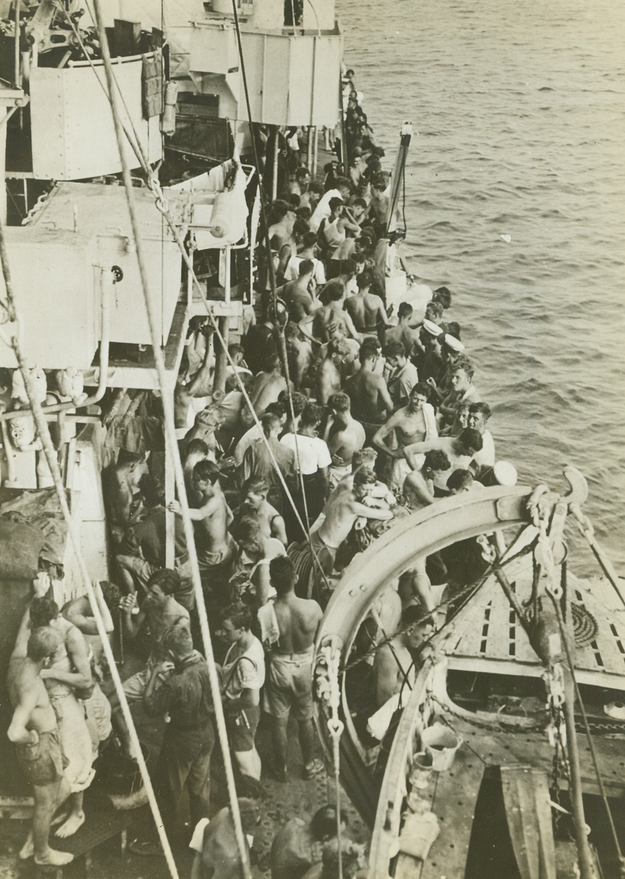 Rescue of Survivors from H.M.S. Dorsetshire, 9/8/1942. Indian Ocean – It’s all past history to these survivors of the British Cruiser H.M.S. Dorsetshire as they crowd the decks of the British Destroyer that came to the rescue, telling their buddies their experiences during the action in the Indian Ocean in which the Dorsetshire and another cruiser were sunk. From their attitudes, you’d think that they were just sunning themselves on deck. Credit: ACME;