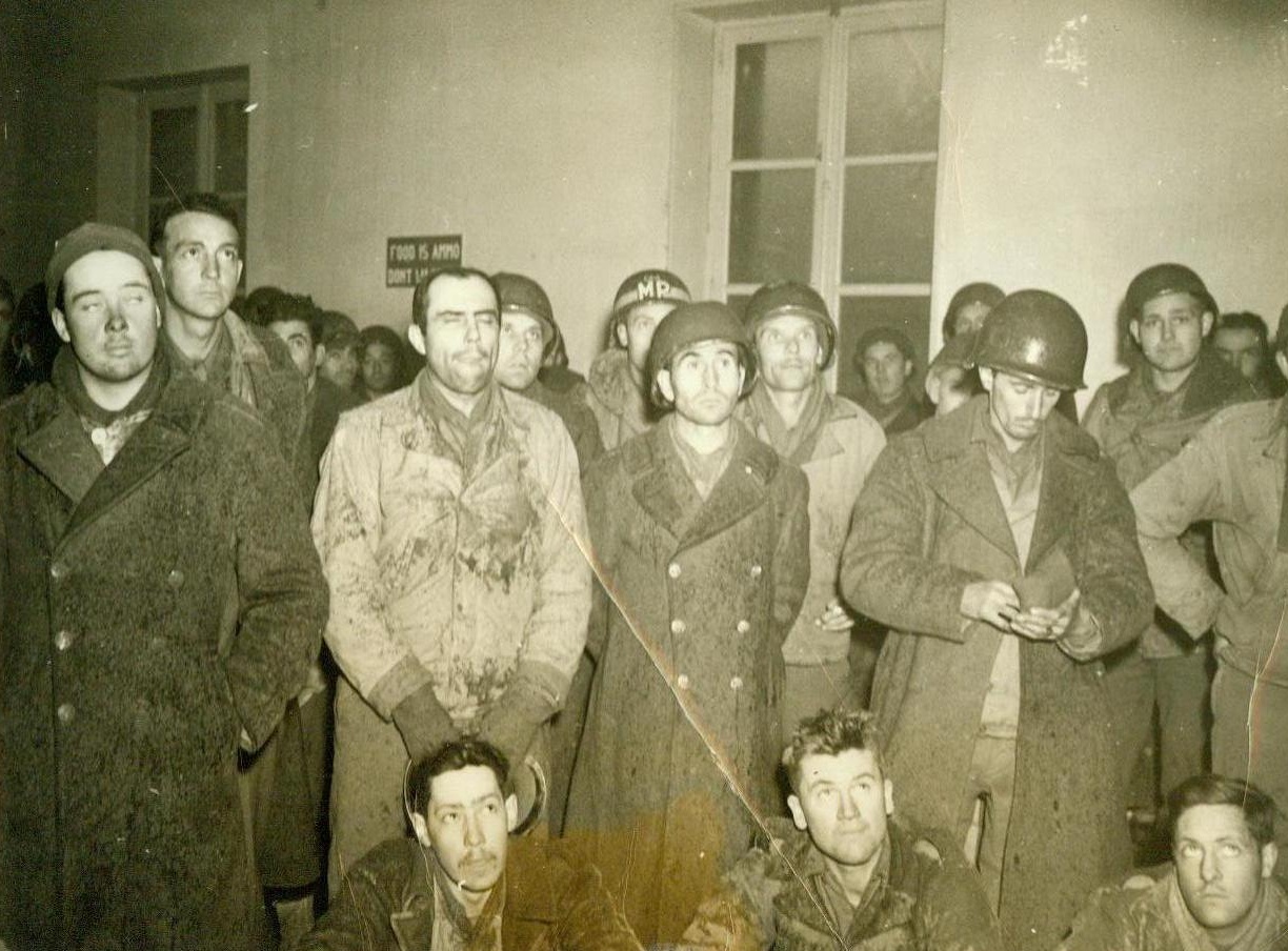 Like “Money From Home”, 12/19/1944. Germany – A study in facial expressions is this photo of men of the U.S. 3rd Army, as they listen to an officer telling them that they have been selected for a 30-day leave. Photo by Charles Haacker, ACME War Pool Photographer 12/19/44 Credit Line (ACME);