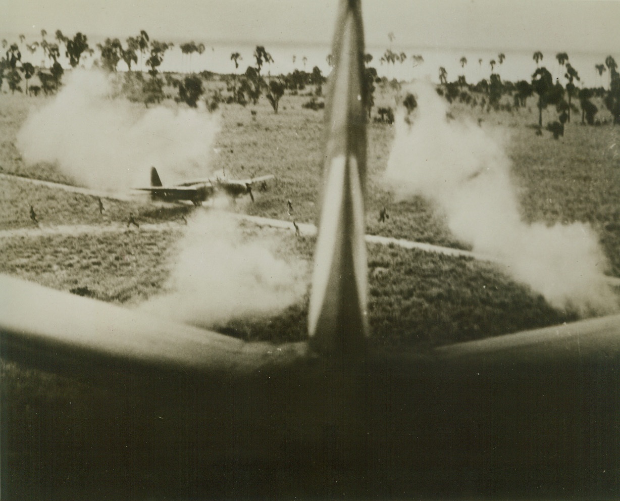 Japs Run During Yank Attack, 10/13/1944. Looking back past the tail of an American plane as it zooms up into position for another attack, Japanese crewmen can be seen running for cover, leaving a Kawasaki “Lily” plane burning on the Selaroe airstrip in the Netherlands East Indies.  Yank aircraft raided the strategic field recently and pilot reported the mission a success. Credit (USAAF Photo from ACME);
