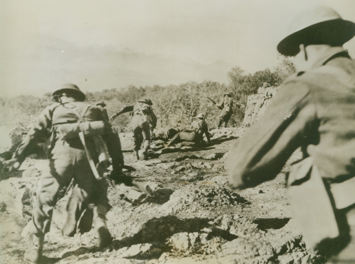 Moving Up, 2/2/1944. Cassino, Italy—Crouching as they dash across the uneven ground, British troops move forward in the Cassino area, on the Allied fifth army front. Credit: ACME.;