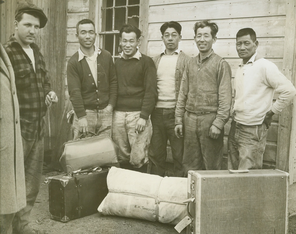 UNWELCOME NEIGHBORS, 4/13/1944. GREAT MEADOWS, N.J.—Five Japanese evacuees who thought they might have a chance to start anew on the muckland farms of New Jersey’s Warren County, packed their bags and prepared to leave Great Meadows as outraged farmers threatened to run them out with shotguns, if necessary. Working on the farm of Edward Kowalick (left), on a tenant basis, where they were placed by the War Relocation Authority, the Japanese have been forced out by the protests of neighbors—and a fire in Kowalick’s shed, which sent seven tons of fertilizer up in flames, caused damages estimated at $800, and proved that the neighbors meant business. The ousted evacuees are: (left to right) Eddie Taniguchi, Frank Kitadawa, Ted Midmura, George Yamamoto and T. Matsumoto.Credit: Acme;