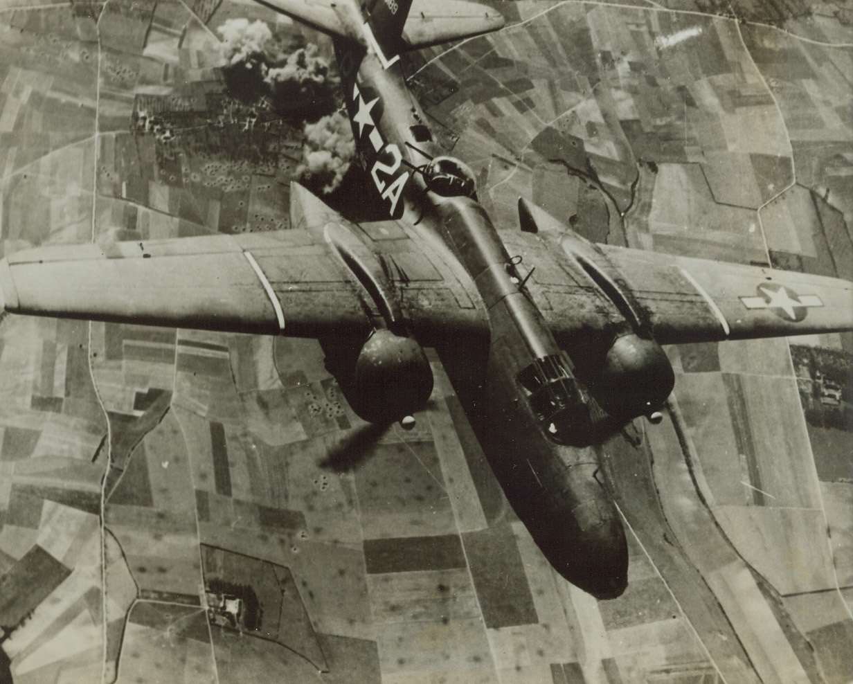 Homeward Bound!, 4/29/1944. Billows of black smoke rising skyward tell the tale of a mission accomplished, and the trim body of this A-20 Havoc attack bomber turns tail and heads for her English base after hitting at Nazi installations on the continent. These fast, light bombers have been operating out of England for several weeks, and their success marks them for an important part in the coming invasion. Credit: Official U.S. ARMY AIR FORCES Photo from ACME.;
