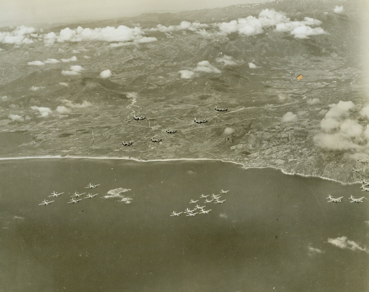 Air “Squeeze Play” on Axis (#3), 4/24/1944. SARDINIA – Hitler’s “Festung Europa” today, is being shattered and rocked by the greatest concentration of aerial might the world has ever seen. Day after day, in mounting numbers and with ever-increasing ferocity, huge masses of Allied bombers and fighters are blasting German war plants, communications, and airfields into crumbling and smoking ruin in preparation for “D Day” – and Allied invasion. These aerial armadas have occupied Europe in a gigantic pincers, with one “leg” in England, and the other in Italy and Sardinia. This series of photos shows U.S. B-26 Marauders taking off and operating from Allied fields in Sardinia, against the Southern Coast of France. Their target was the Var River railroad bridge near Nice. ---Here, high over the coastline of Sardinia, the Marauders in groups of six, roar toward Southern France.Credit Line (Acme Photo by Charles Seawood from the War Picture Pool);