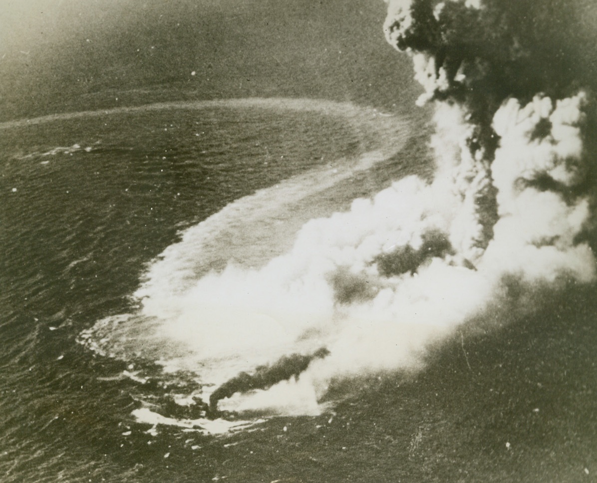 “Death Rattle”, 4/7/1944. Truk – Enveloped in steaming smoke and sea water, a Japanese destroyer wriggles in its “death rattle” before going down to the bottom of Truk Harbor.  The victim of a  Grumman avenger, it was one of 23 Japanese ships sunk during the U.S. Navy task force raid on Truk on February 16th and 17th. Credit line (official U.S. Navy photo from ACME);