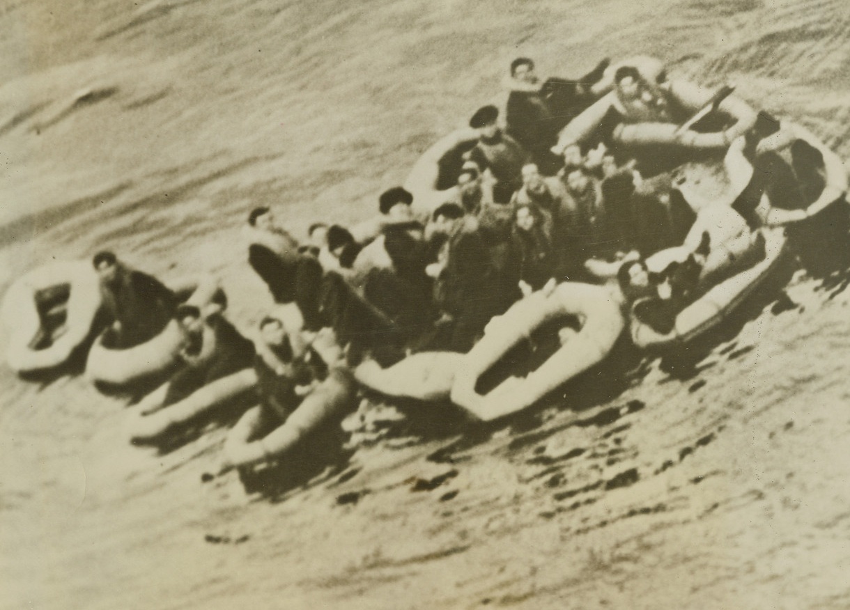 NAZIS ESCAPE DEATH IN U-BOAT, 4/27/1944. SOMEWHERE IN THE ATLANTIC – RCAF Coastal Command Sunderland flying boats attacked a German submarine in the Atlantic and sank it after accurate depth-bombing.  The crew of the U-boat escaped the sinking undersea craft in one-man dinghies.  Photo shows a group of the Nazis escaped from death, maneuvering their individual dinghies after leaving the sinking sub.Credit: Acme;
