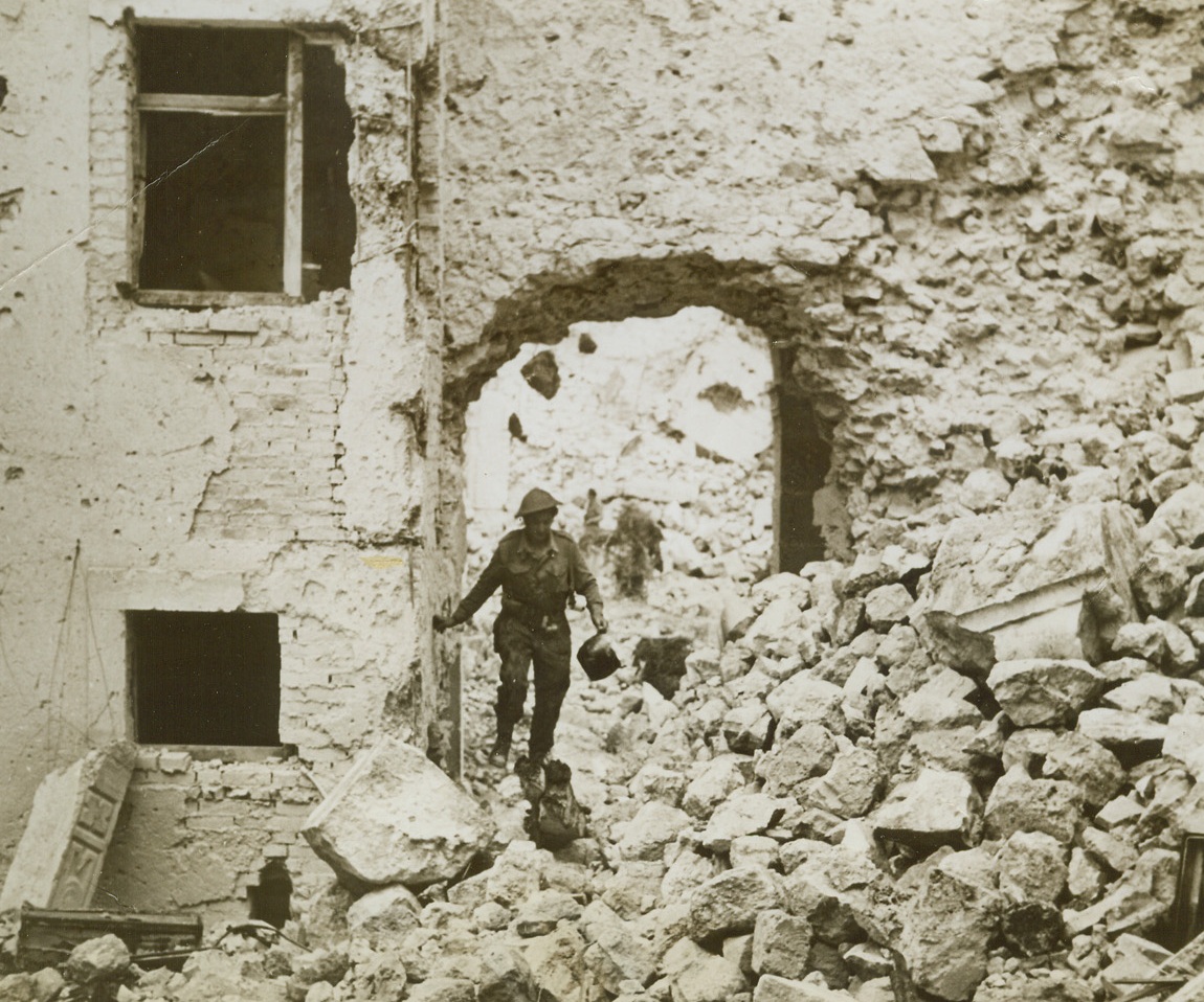 Only Rubble Remains, 5/25/1944. CASSINO, ITALY—The crumbled walls of the ancient Benedictine Monastery overlooking Cassino, torn down by intensive bombardment by Allied planes and long range artillery pieces, make the going rough for a fighting man who picks his way through the debris. Although the old house of worship was in ruins when captured by the Allies, our military leaders are confident that the building can be restored.Credit Line – WP- (ACME);