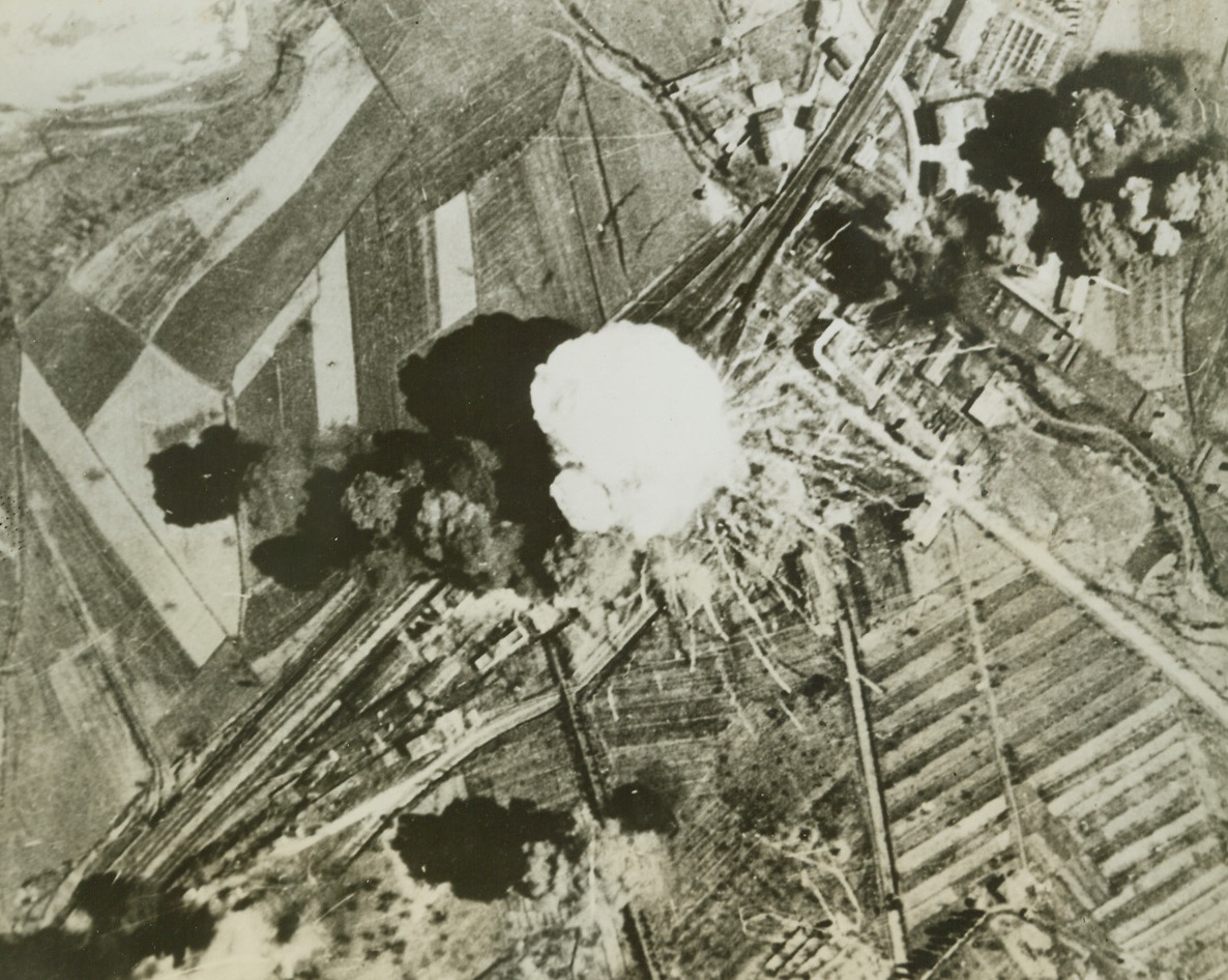 Bullseye for Yank Bombers, 5/2/1944. An enemy ammunition train goes up in a huge cloud of smoke as it is hit directly by bombs from B-25 Mitchells of the U.S. 12th Air Force, during a recent raid. On the railroad yards at Orvieto, Italy, 60 miles north of Rome, on the main line to Florence. Allied bombers have kept service on the rail lines in Northern Italy virtually at a standstill. Credit: USAAF photo from ACME.;