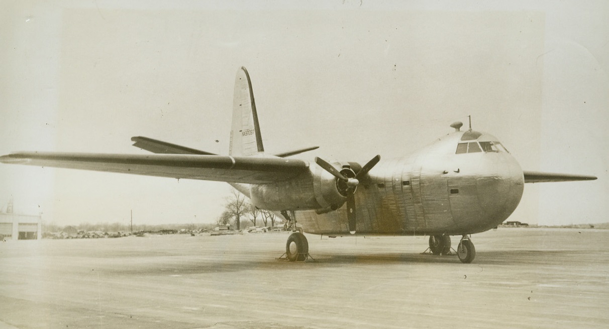 Secret Navy Cargo Plane Revealed, 5/6/1944. Philadelphia, Pa.—This is the new “Conestoga,” super cargo plane so named in tribute to the amazing vehicle which helped pioneer the settlement of colonial territories west of the Alleghenies. The plane, built by the Edward G. Budd Manufacturing Company under Navy contract, is of a brand new type which utilizes welded stainless steel instead of rivoted aluminum alloy sheets. Sixty-eight feet long, this two-engine transport has a wing spread of 100 feet, and is capable of transporting 10,400 pounds of cargo over a range of 650 miles, housing the load in a cargo compartment 25 feet long, eight feet wide, and eight feet high wholly unobstructed by girders or other structural members. Credit: ACME.;