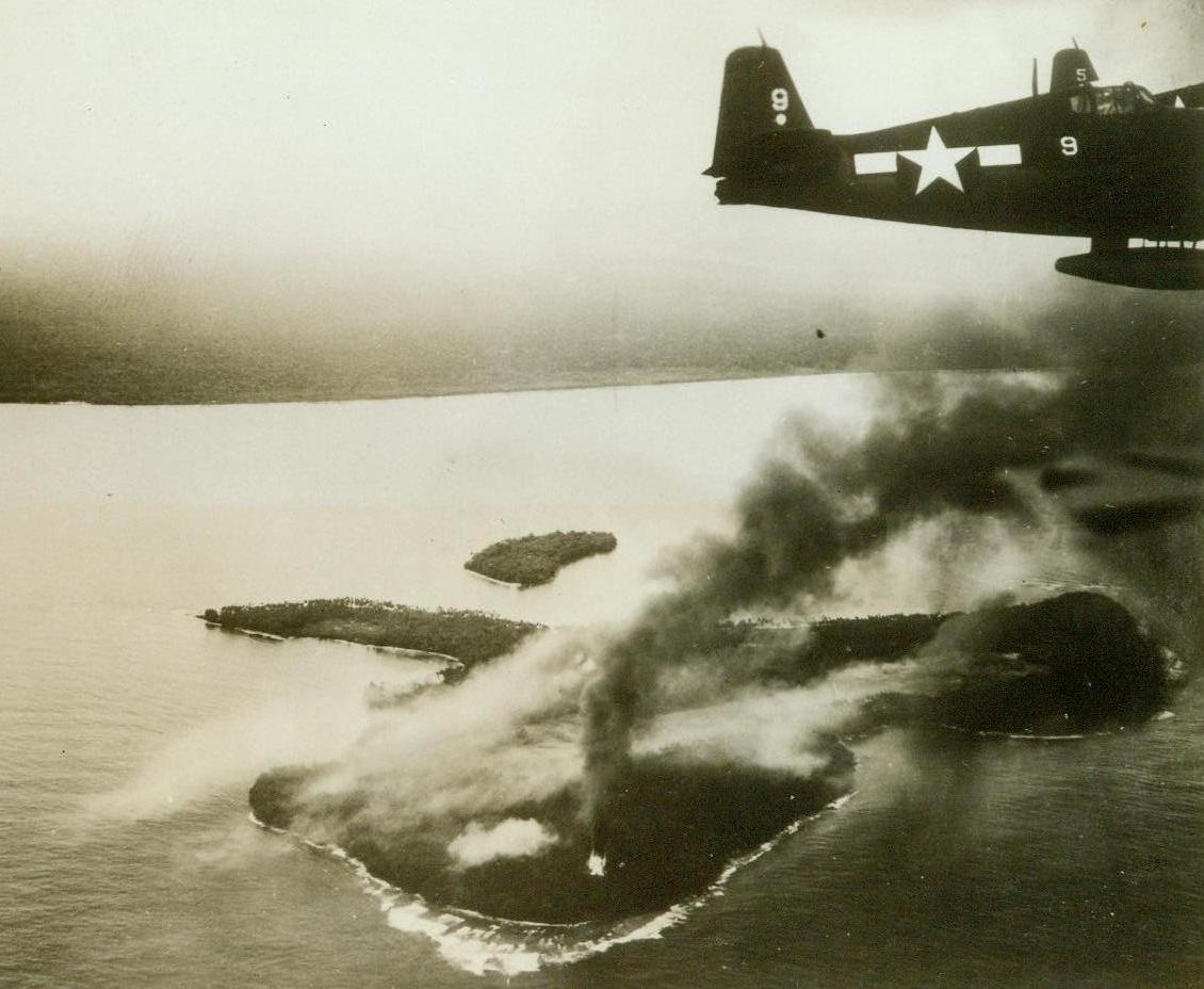 How To "Imobilize" Enemy Craft, 5/27/1944. New Guinea – Striking one day before the invasion of Hollandia, Navy Carrier-based planes from the giant task force which participated in the landings, blasted nearby Wakde Island. A Navy warplane is seen zooming far over burning Wakde after dropping its bombs. The Wakde Airfield was heavily hit; destroying many planes and “imobilizing” the field as a source of counterattack against the operation the following day. A month after the Hollandia victory, Wakde itself was taken. 5/27/44 (US Navy Photo From ACME);