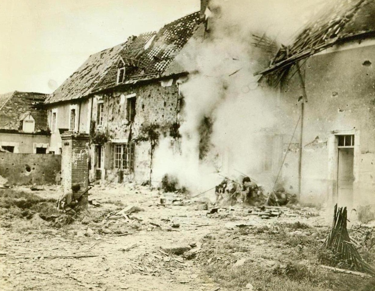 Doom For Snipers, 7/24/1944. Saintenay, France - Taking cover behind a brick pillar and a pile of rubble, American infantrymen send bullets whizzing into a snipers nest in Saintenay. Their prey hides in the bomb-ruined houses in background. Credit: ACME;