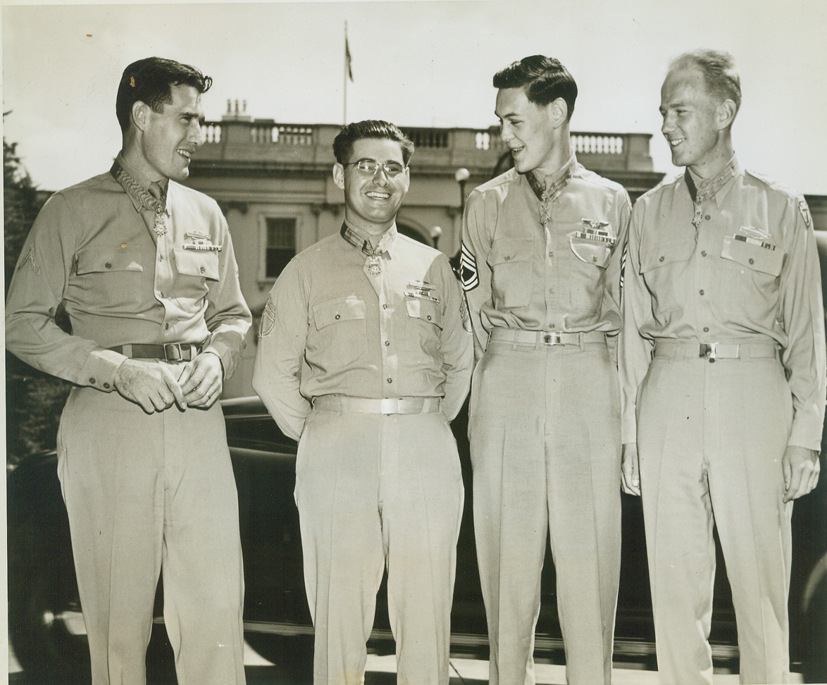 RECEIVE NATION’S HIGHEST AWARD FROM FDR, 8/30/1944. Washington, DC – On the White House lawn is this quartet of war heroes after each had been presented with the Medal of Honor, the Nation’s highest award for gallantry, by President Roosevelt.  They are (left to right) Pfc. William J. Johnston, Colchester, Conn., machine gunner who held off two German counterattacks and stuck to his gun although his comrades thought him mortally wounded; S/Sgt. Jessie R. Drowley, Luzerne, Mich., who was cited for heroism on Bougainville; T/Sgt. Forrest L. Vosler, Livonia, N.Y., who received an eye injury and other wounds on a Bremen raid and asked to be tossed from the plane to lighten its load; and 1st Lt. Arnold L Bjorklund, Seattle, Wash., who used three hand grenades to destroy two machine guns, a heavy mortar, and to kill seven Germans. NY#12 DJH LON 70 CEP LV SEA CAN.  Credit Line (ACME);