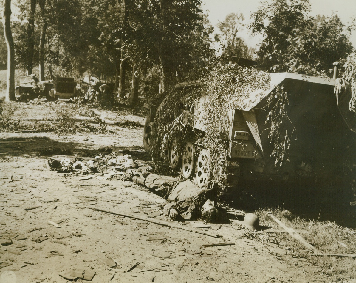 Attempted Retreat Ends in Death, 8/22/1944. FRANCE – This German soldier was killed s he attempted to flee from his half-track vehicle as German forces retreated toward Mortain, France.  Other vehicles in his unit (background) were also knocked out as they fled homeward. Credit; (Signal Corps Photo From ACME);