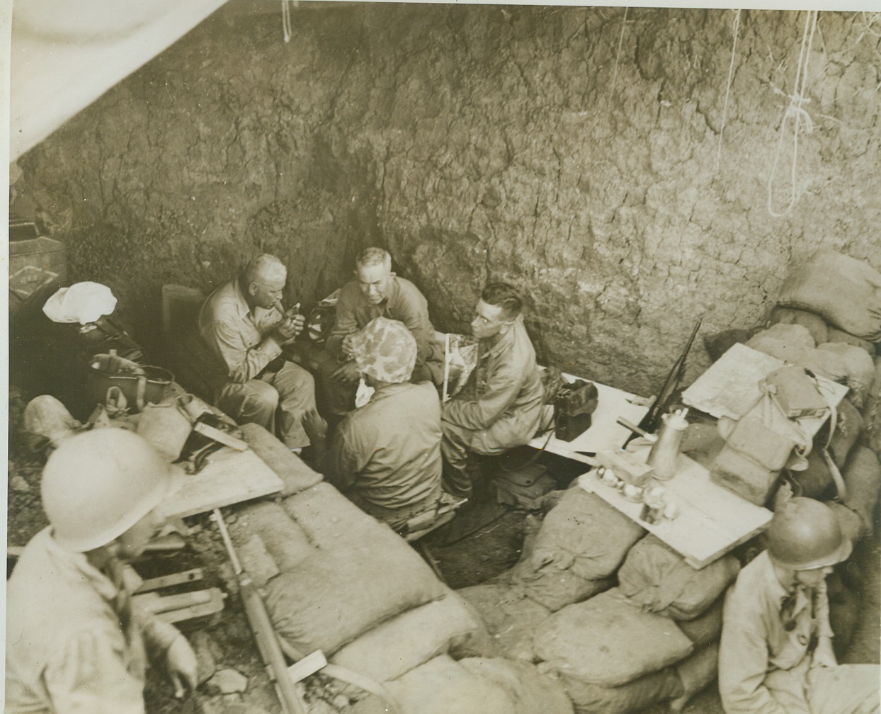Underground Guam Command Post, 8/22/1944. GUAM -- In this super foxhole turned into a command post on Guam, Maj. Gen. Roy S. Geiger (left), commander of Third Marine Amphibious Corps, confers with Maj. Gen. Allen H. Turnage, USMC. Sand bags and alert sentries furnish additional protection against possible Jap interruption of this battlefront strategy huddle.  Credit (Marine Corps Photo from ACME);
