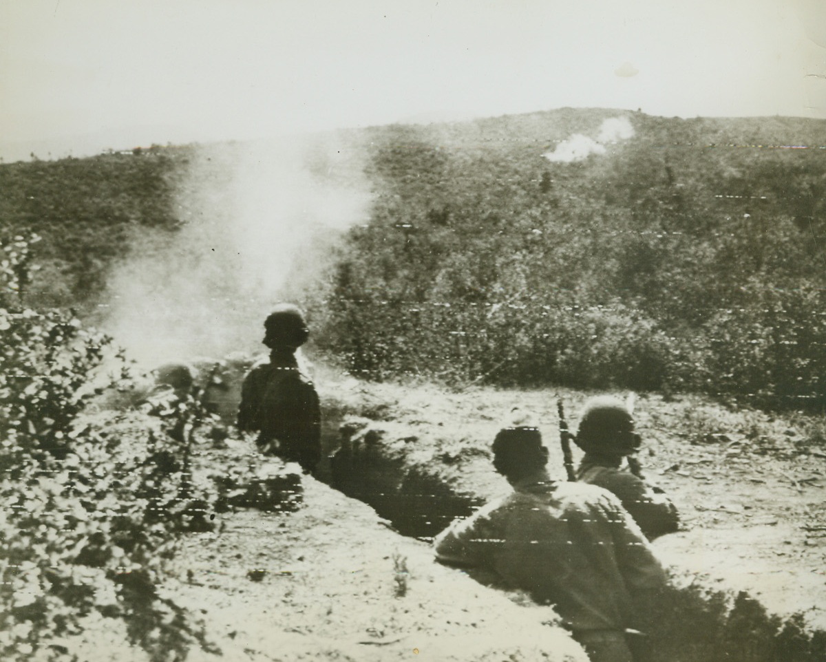 Jap-Americans Fight in Italy, 8/14/1944. ITALY – Proving their loyalty on the battle front are these two Jap-Americans fighting in Italy. Combing for snipers, Pvt. Veikichi Arakaki, from Koloa Kauai, T.H. (Hawaii), and a buddy at left, fire rifle grenades into the hills. Bursts can be seen on the hillside.Credit (Signal Corps Radiotelephoto from Acme);