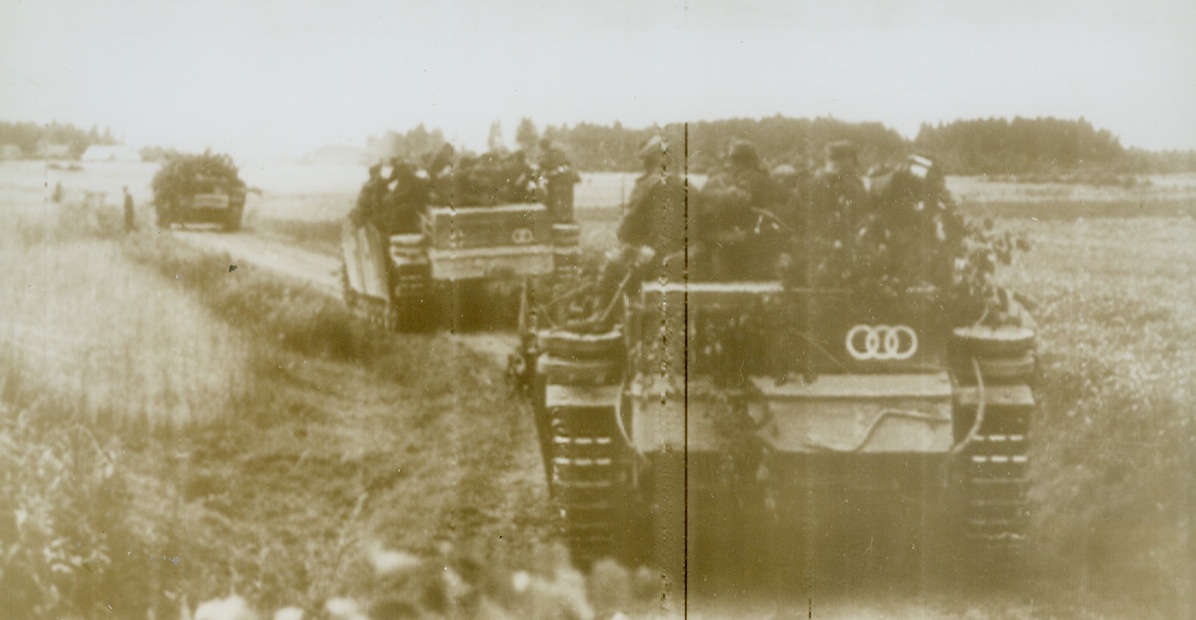 Tank Evacuation for German Soldiers, 8/22/1944. According to the German caption accompanying this photo, radioed from Stockholm today (August 22), the picture shows “a defense battle on the east front.” It actually shows tanks being used to transport German soldiers in their retreat from the front.Credit (Acme Radiophoto);