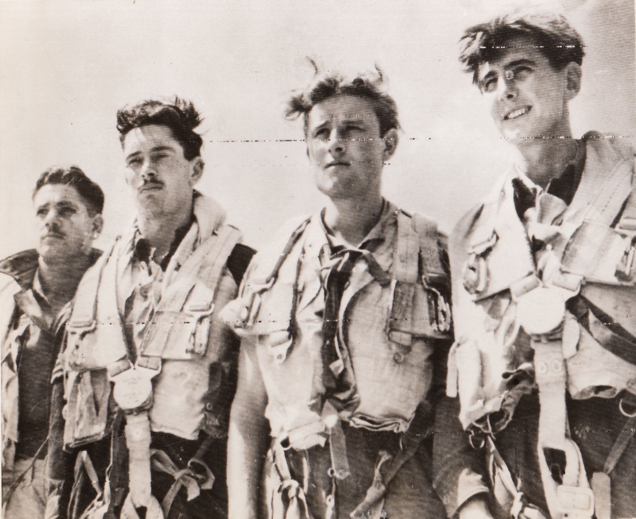 Flew Supplies to Warsaw Patriots, 8/23/1944. ITALY – Back at their base in Italy are these four members of an RAF Liberator crew who recently flew from Italy to Warsaw and back to drop supplies to patriots battling the Nazis in the Polish capitol. They are (left to right): F/S Kenneth Pearce, Sgt. Peter Green, Sgt. Derek Coates, and Sgt. John Rush.;