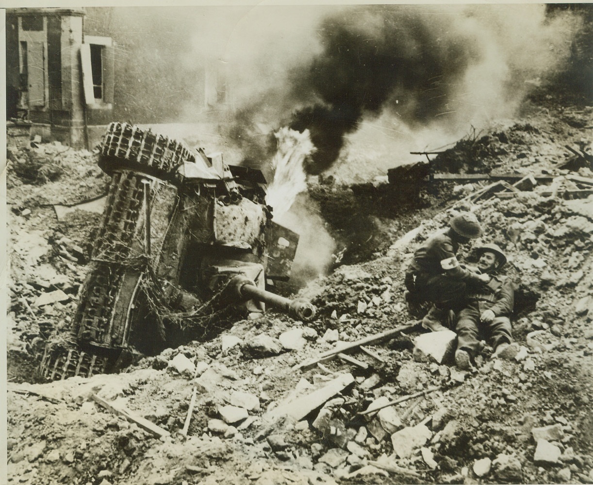 Trap Closes on Nazis, 8/16/1944. FRANCE -- A German tank, overturned in a deep bomb crater, burns fiercely along the road to Falaise, where Allied forces are closing a trap on the German 7th Army, which has already been torn to ribbons. At right (photo above) a medical orderly looks over a Canadian soldier who has fallen but is uninjured. Credit: (ACME) (WP);
