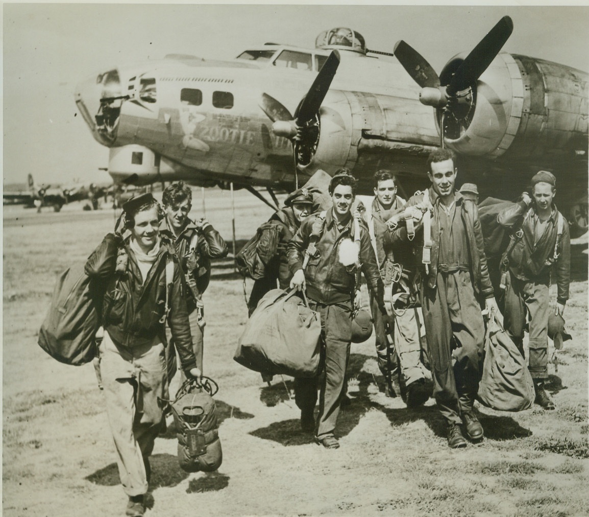 Yank Return from Raid, 8/22/1944. ENGLAND -- American airmen walk from their Fortress bomber on returning to their base in Britain after raiding strategic targets in Alsace Lorraine. They are (left to right): T/Sgt. Harry Soderburg, Lueders, Tex.; T/Sgt. Fernand Savasuk, Winslow, Me.; 1st Lt. Richard Davies, Congers, N.Y.; S/Sgt. Bernice Stanton, Cookville, Tenn.; 2nd Lt. Joseph Hughes (rear), Pittsburgh, Pa.; 2nd Lt. Harry Neumann, Union City, N.J.; S/Sgt. Raymond Glasser, Little Sioux, Iowa; Sgt. Mervin Wingard (rear), Kittaning, Pa.; and Sgt. Bill Baker of Chanute, Kansas. Credit: (ACME);