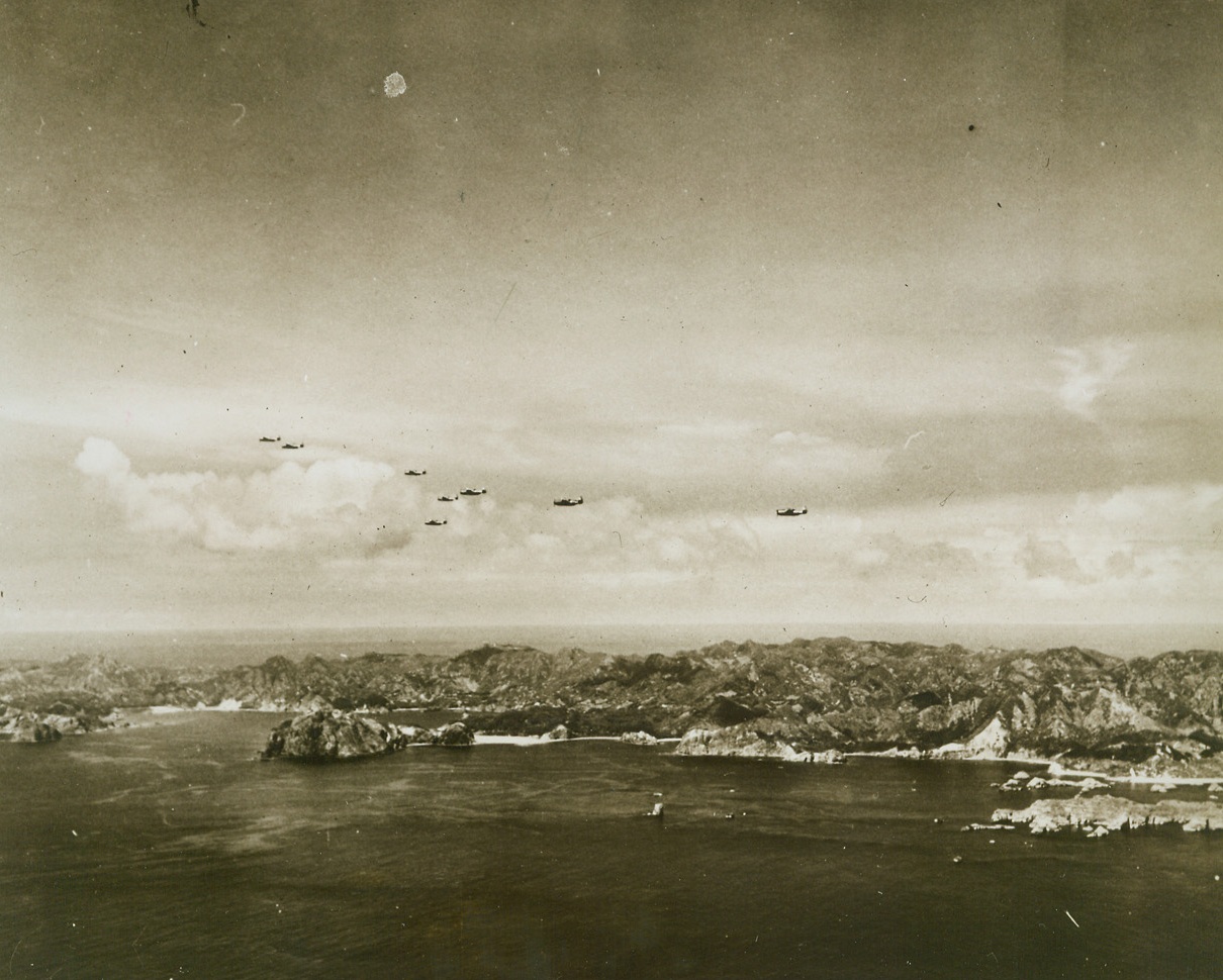 Navy Force Strikes in Bonins, 8/9/1944. BONIN ISLAND – Swift and deadly, eight Grumman Avengers of a hard-hitting Pacific fleet task force glide over the gnarled shoreline of Chichi Jima in the Bonin Islands, only 600 miles south of Tokyo. Our planes destroyed 13 Jap ships and 32 planes; they damaged more than 20 ships and 96 planes. Credit: Official U.S. Navy photo from ACME;