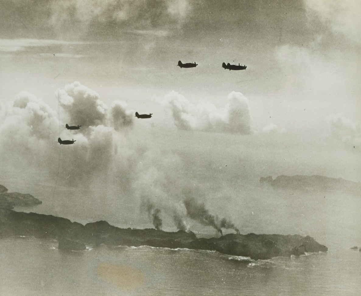 Only 600 Miles from Tokyo, 8/9/1944. BONIN ISLANDS – With smoke rising from the ruins of four ships at Haha Jima below them, five helldivers of a Pacific Fleet task force slip back into formation to return to their carriers. In attacks on Haha Jima and Chichi Jima, both in the Bonin group, 600 miles south of Tokyo, our planes sank at least 13 Jap ships and damaged more than 20. Thirty-two enemy planes were shot down and 96 were damaged. Credit: Official U.S. Navy photo from ACME;