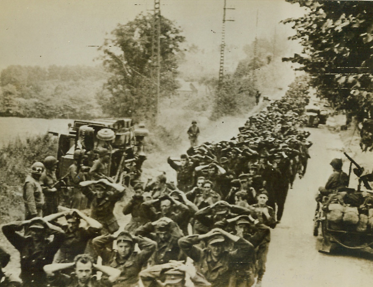 RESULTS OF YANK BREAKTHROUGH IN BRITTANY, 8/5/1944. FRANCE—Hundreds of German prisoners are marched to the rear after being captured during the initial stages of the current Yank offensive in Brittany.;