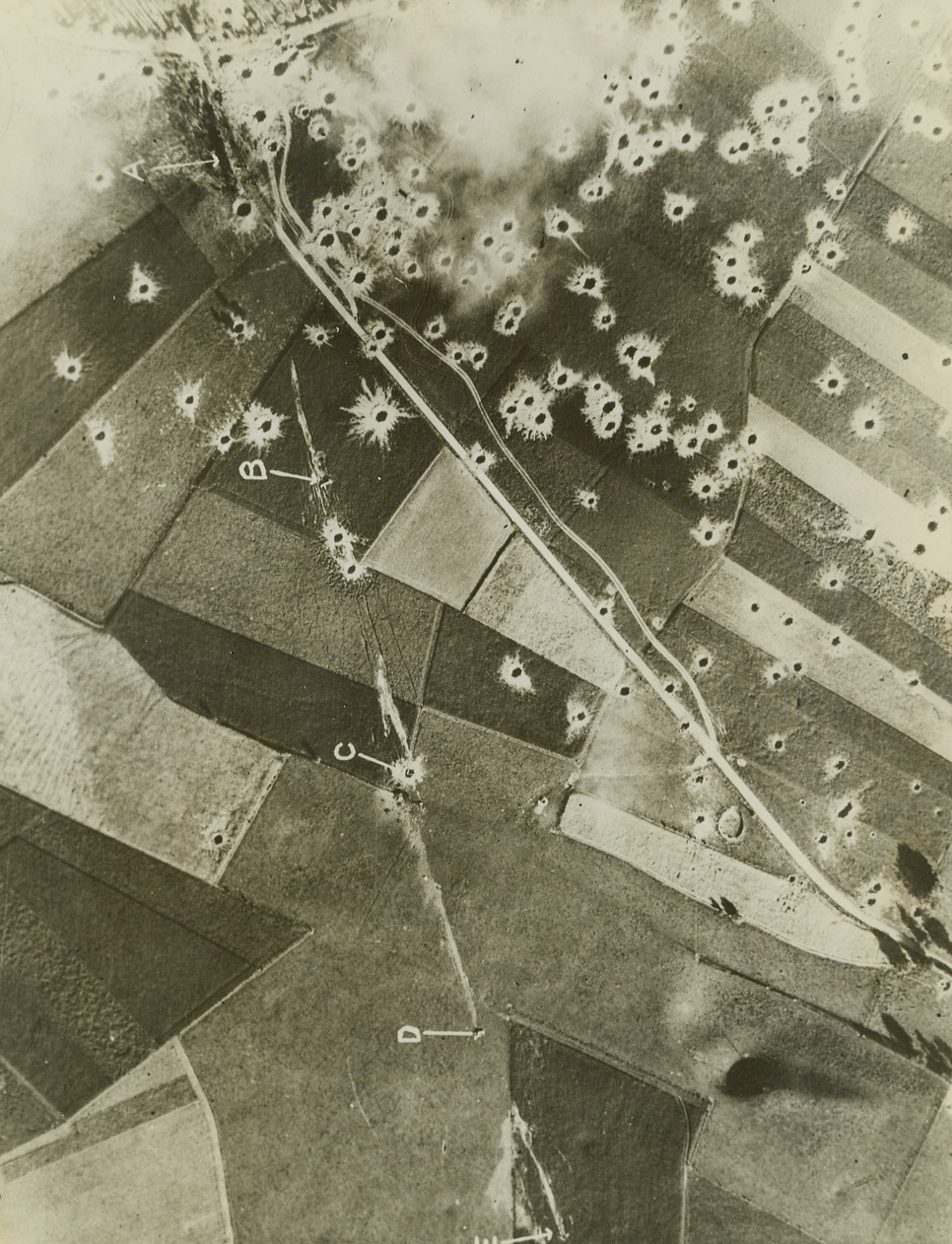 FLYING BOMB SITE BLASTED, 8/15/1944. FRANCE—A reconnaissance photo of a German Robot flying bomb site in the Pas de Calais area which has been attacked by Allied aircraft. Letter A, shows the launching platform surrounded by bomb craters. B,C,D, and E are flying bombs which have crashed on launching. Credit Line (British Official Photo from ACME);